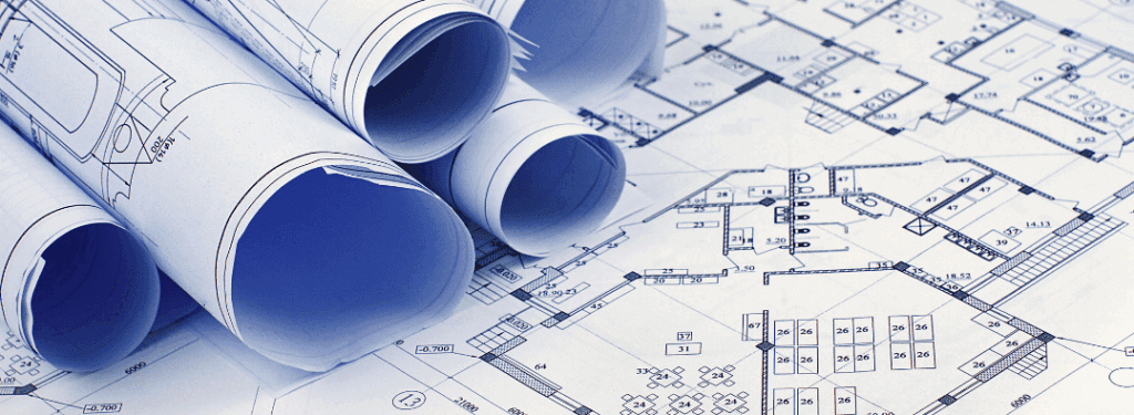 Blueprint of an office building and other rolled up blueprints